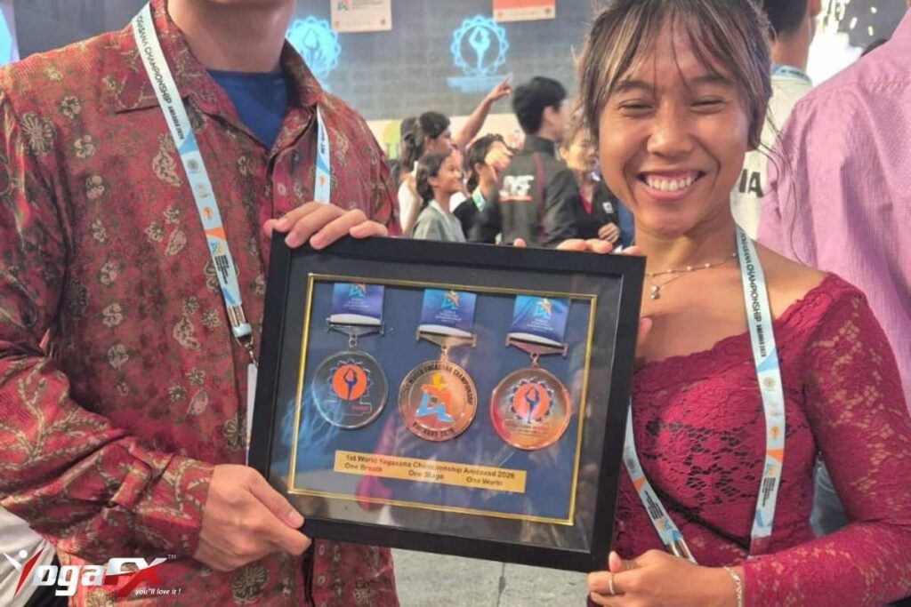 Ivara Candra Kartika YogaFX Seminyak studio teacher holding gold and bronze medal at World Yogasana Sport Championship 2026