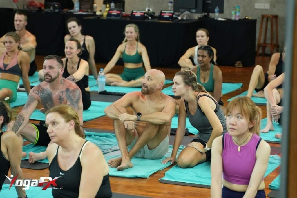 First-time student preparing mat and towel before a 90-minute hot Bikram yoga near me class at Bikram Yoga FX Bali's Seminyak studio.