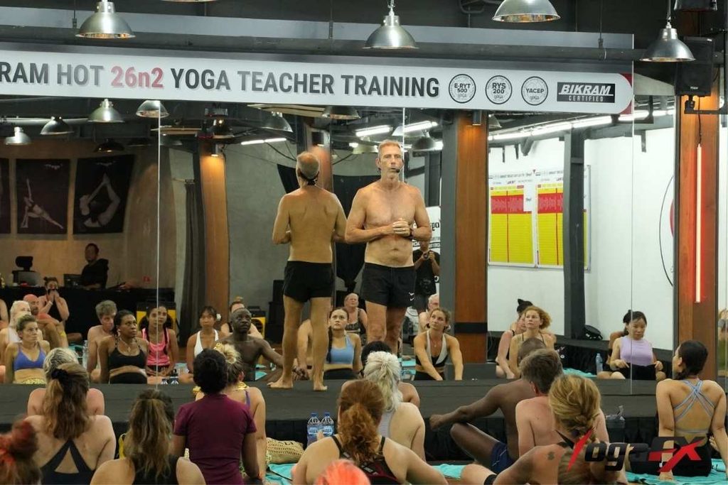 Certified instructor guiding a Bikram Hot 26 and 2 class through verbal dialogue without music or demonstration, the teaching method that separates authentic studios from imitators