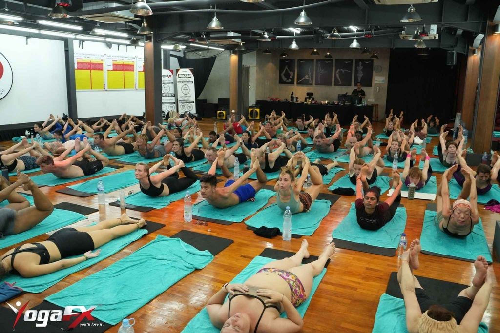 Trainees in a yoga teacher training session at YogaFX in Seminyak, one of the best yoga teacher training options in Bali for hot yoga