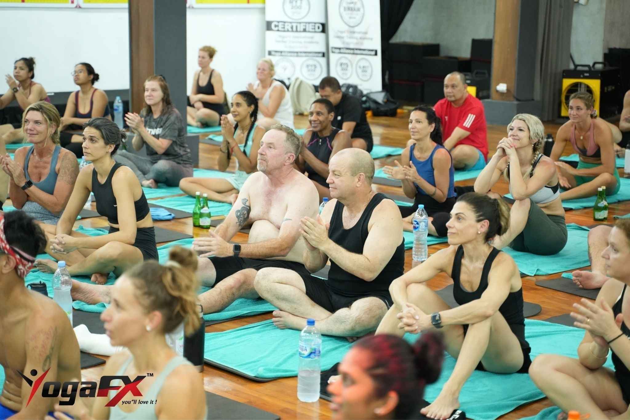 Student resting calmly in Savasana after a hot yoga class for anxiety and stress relief at the YogaFX studio in Seminyak, Bali